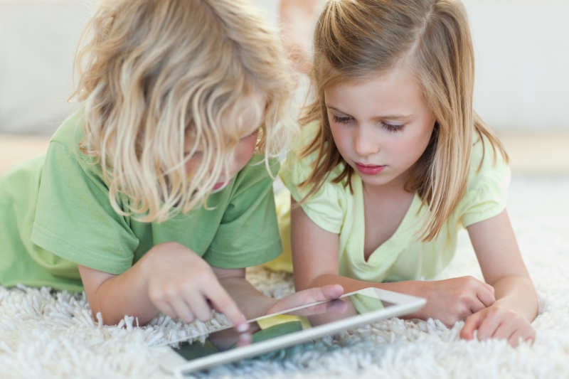 3618887-siblings-on-the-floor-using-tablet